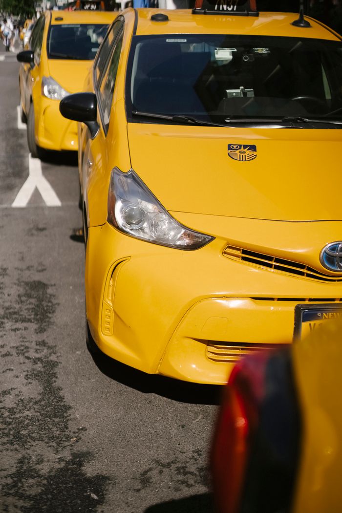 services-img From above of bright yellow modern sports cab cars parked on urban roadway in sunlight